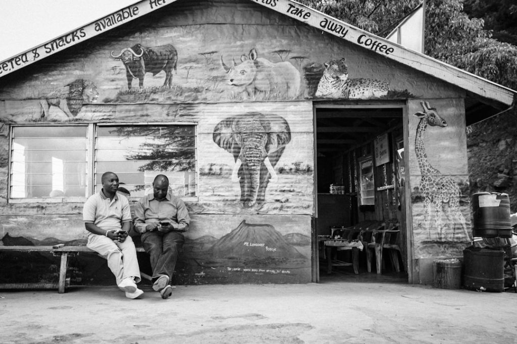 grayscale-photography-of-two-men-sitting-on-bench-rc-3tdhpapc
