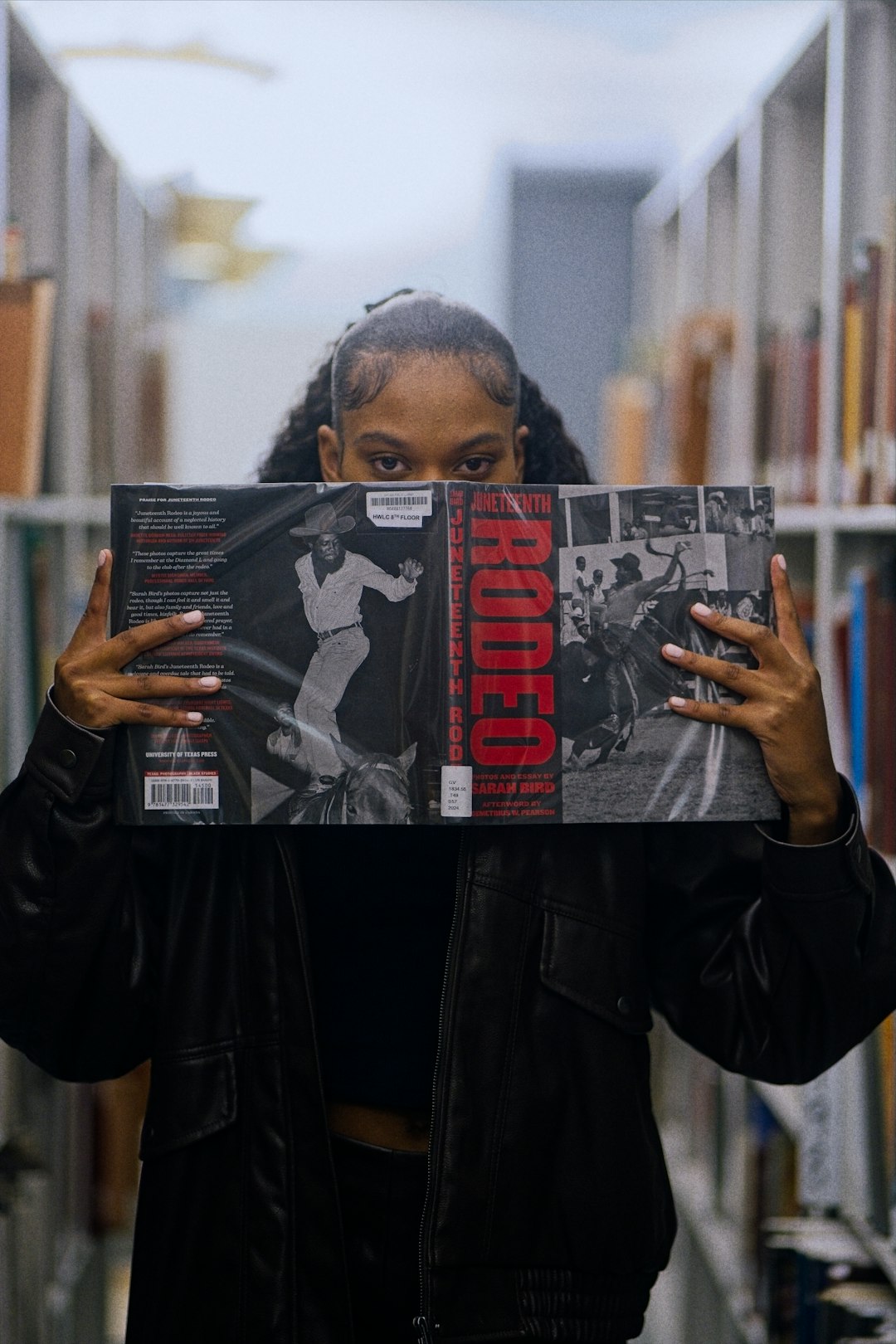woman-holding-a-record-album-in-a-library-dkd0mwsnibe
